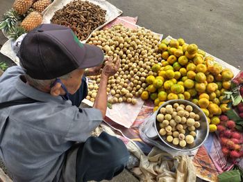 High angle view of man preparing food at market stall