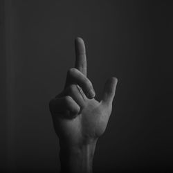 Close-up of human hand against black background