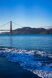 View of suspension bridge over sea