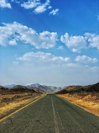 Road along landscape against sky