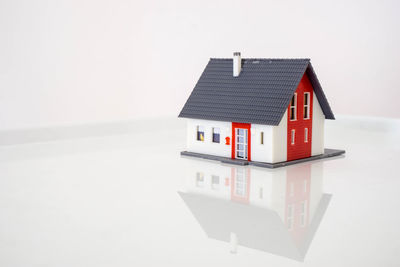 Model house on table against white background