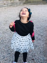 Portrait of smiling girl standing outdoors