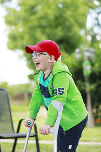 Happy boy in garden using cru