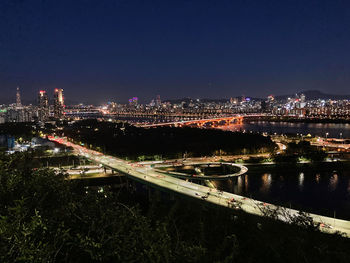 High angle view of illuminated buildings in city at night