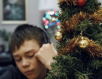 Boy by decorated christmas tree 