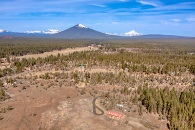 Scenic view of land and mountains against sky