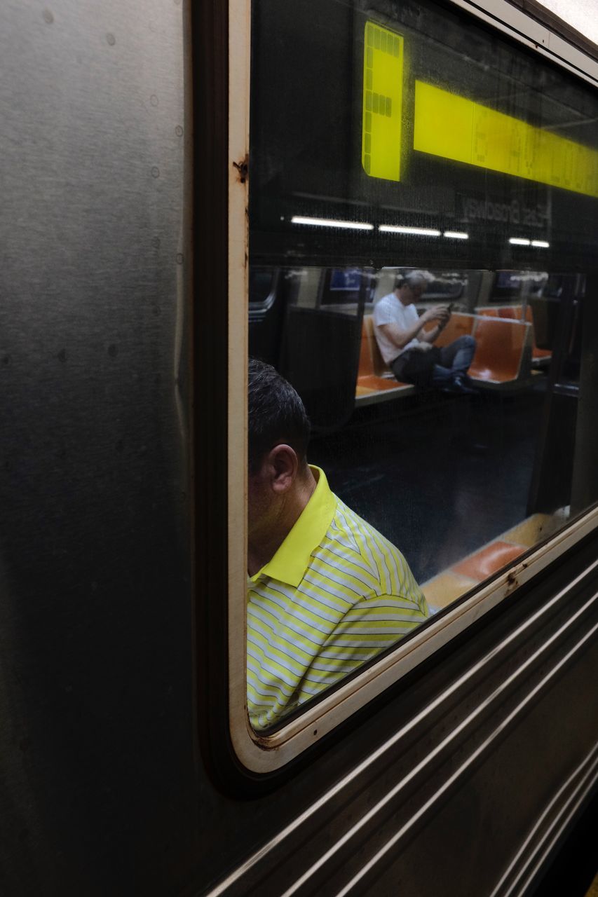 mode of transportation, one person, real people, window, land vehicle, childhood, public transportation, child, transportation, indoors, portrait, glass - material, boys, men, vehicle interior, lifestyles, reflection, rail transportation, train, innocence