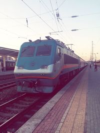 Train at railroad station against sky