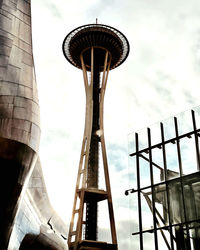 Low angle view of tower against cloudy sky