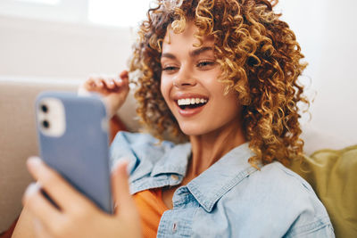 Portrait of young woman using mobile phone