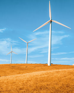 Windmill on field against sky