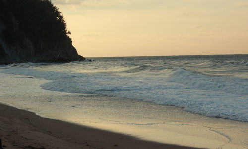 Scenic view of beach against sky during sunset