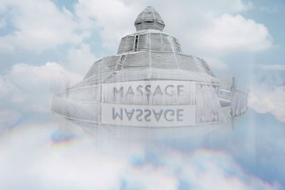 Digital composite image of building with message against cloudy sky