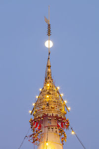 Low angle view of illuminated building against sky