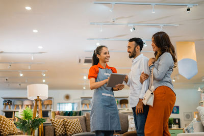 Portrait of female friends standing in cafe