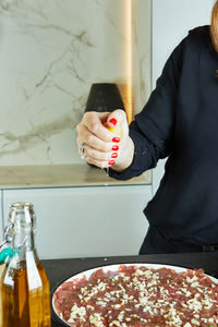 Midsection of man preparing food at home