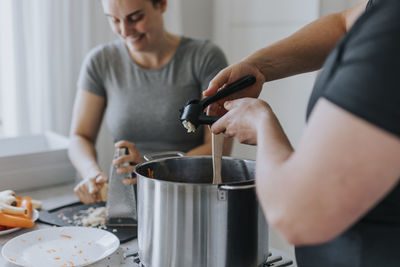 Couple in kitchen preparing food together