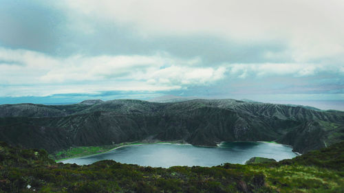 Scenic view of sea and mountains against sky