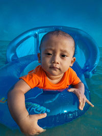 Portrait of cute boy in swimming pool