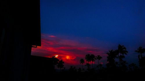 Silhouette trees against sky at sunset