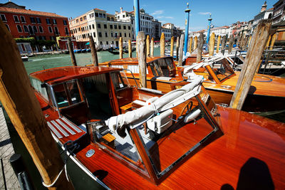 Motorboats moored at harbor on sunny day