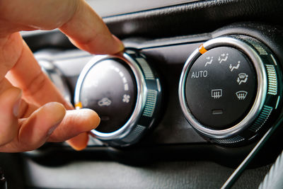 Close-up of hand holding camera in car