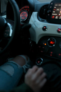 Cropped hand of woman driving car