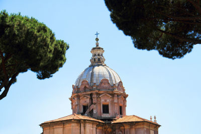 Low angle view of santi luca e martina against clear sky in city