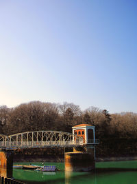 Bridge over river against clear sky