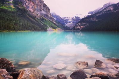 Scenic view of lake and mountains against sky