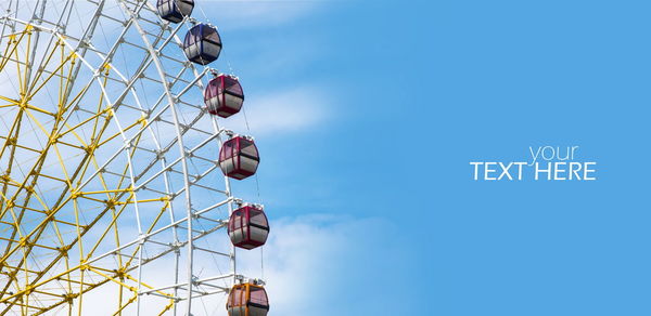 Low angle view of ferris wheel against sky