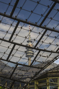 Low angle view of communications tower against sky