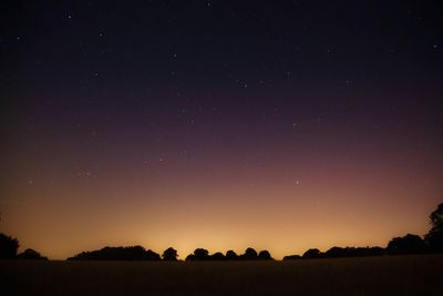 Scenic view of landscape against sky at night