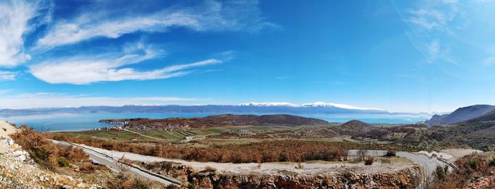 Panoramic view of landscape against blue sky