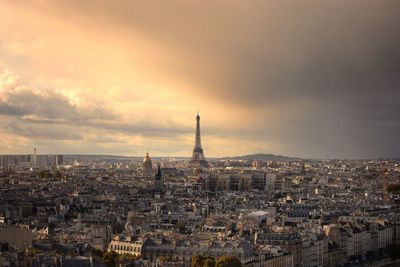 View of cityscape against cloudy sky