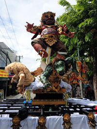 Low angle view of statue against sky in city