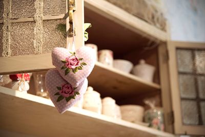 Pink flowers on shelf at home