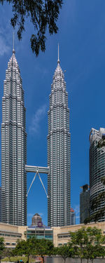 Low angle view of modern buildings against blue sky