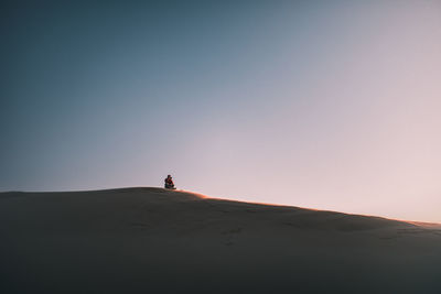 Man on desert against sky