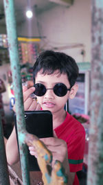 Portrait of mature man using mobile phone