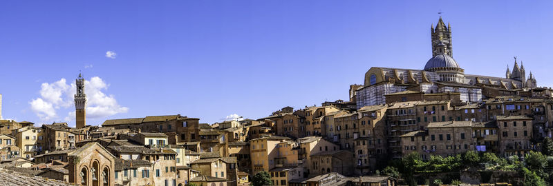 Panoramic view of siena with tiled rooftops, duomo and torre del mangia - tuscany, italy