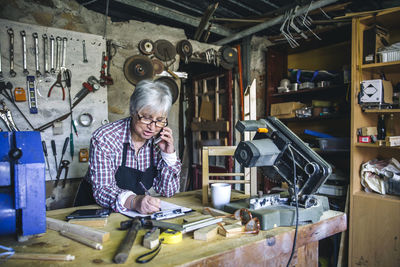 Senior woman working at workshop