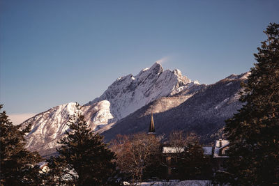 Scenic view of snowcapped mountains against clear blue sky