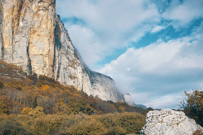 Low angle view of rock formation against sky