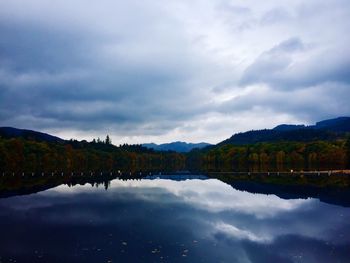 Scenic view of lake and mountains against sky