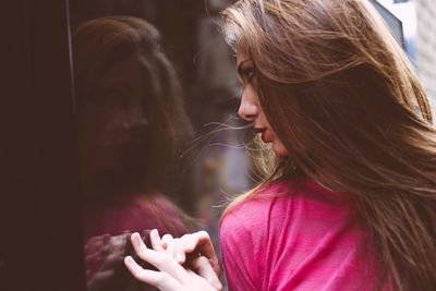 Close-up of young woman holding hair