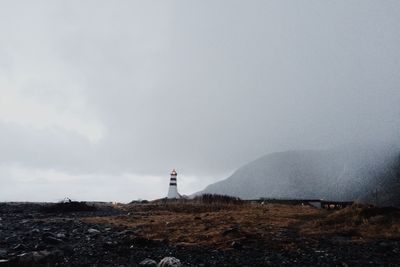 Distant view of lighthouse against sky