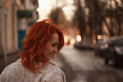 Redhead woman in city