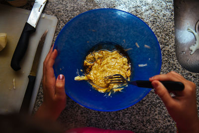 High angle view of woman preparing food in bowl