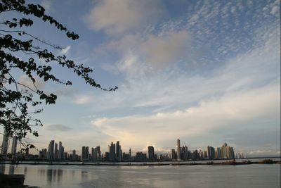 Cityscape against cloudy sky